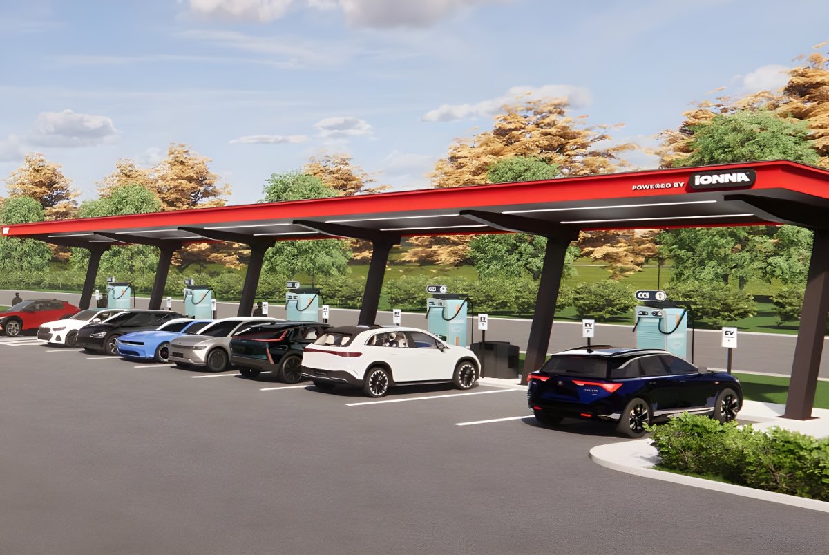 Digital rendering of an Ionna EV charging station with multiple cars parked under a red canopy.