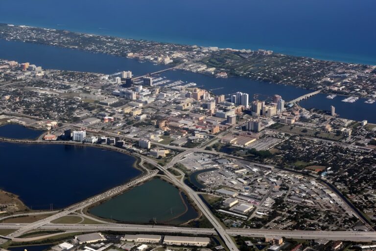 Aerial view of West Palm Beach skyline, Lake Worth Lagoon, and coastal infrastructure in Palm Beach County.