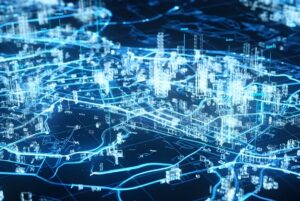 Digital 3D wireframe map of a city with glowing blue lines representing infrastructure and data networks.