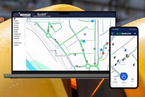 Laptop and smartphone displaying the MOVISAT EcoSAT IoT platform with city maps and fleet tracking data.