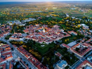 Aerial drone view of Karlovac, Croatia, featuring the historic star-shaped fortress city center and red-roofed buildings.