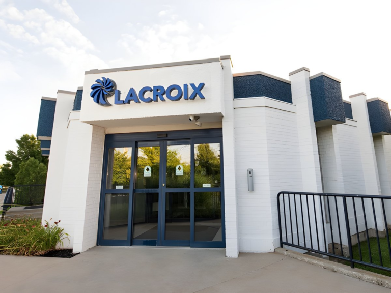 Exterior of a white and blue Lacroix office building featuring a glass sliding door entrance and company signage.