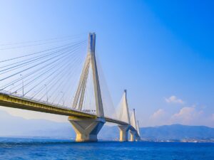 The Rio-Antirrio cable-stayed bridge spanning the Gulf of Corinth in Greece under a clear blue sky.