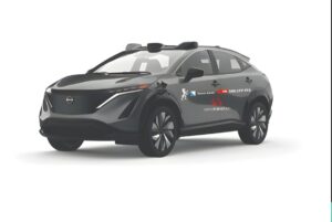 A Nissan Ariya with roof-mounted sensors and SBB CFF FFS branding on the door against a white background.
