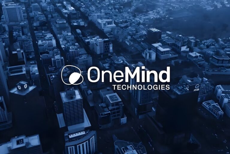 OneMind Technologies logo overlaid on a blue-toned aerial view of a dense urban city grid with skyscrapers.