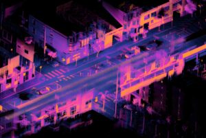 Ouster lidar point cloud visualization of a city intersection with buildings, crosswalks, and vehicles in pink and blue.