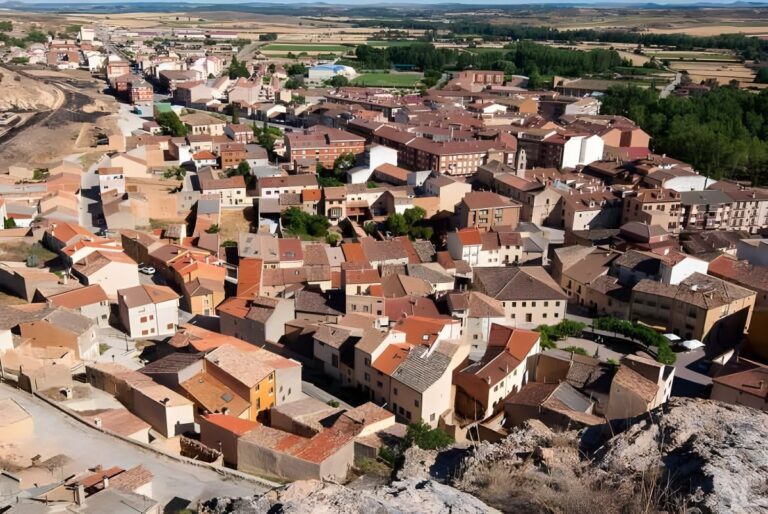 High-angle aerial view of a rural Spanish town with terracotta tile roofs in Soria Province.