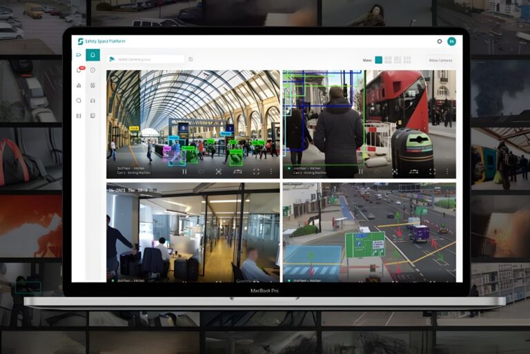 Laptop displaying Remark Holdings AI software with four video feeds showing object detection in public urban spaces.