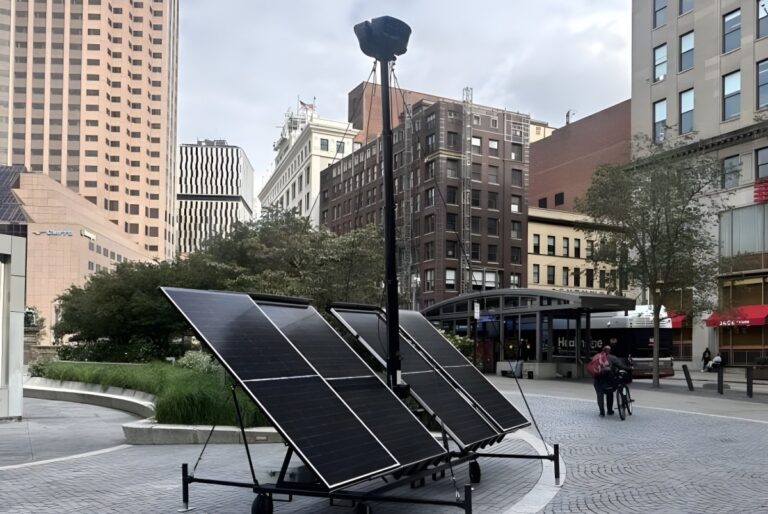 Robotic Assistance Devices ROSA security camera mounted on a solar-powered mobile trailer in a downtown Cleveland plaza.