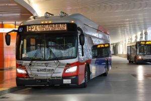 A SamTrans bus with an EPX East Palo Alto digital sign parked at a transit terminal.