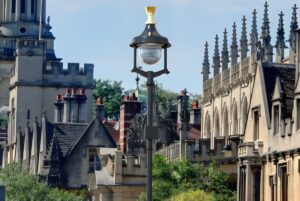 A Signify street lamp with a 5G small cell node integrated into the pole against the Oxford city skyline.