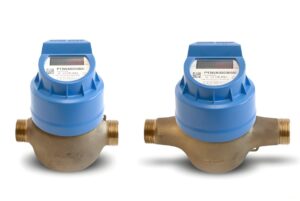 Two digital smart water meters with blue plastic housing and brass pipe fittings on a white background.