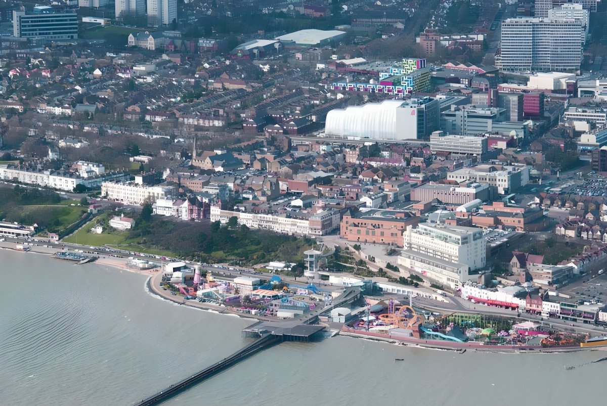 Aerial view of Southend-on-Sea coastline featuring the pier, amusement park, and urban residential developments.