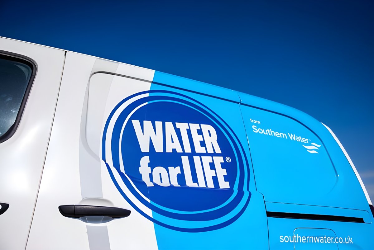 Close-up of a white Southern Water utility van featuring the Water for Life logo against a clear blue sky.