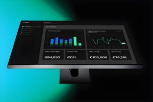 Trawa energy management dashboard on a computer monitor displaying consumption charts and cost data.