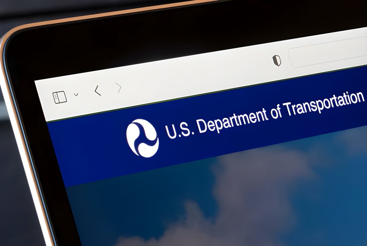 Close-up of a laptop screen displaying the U.S. Department of Transportation logo and website header.