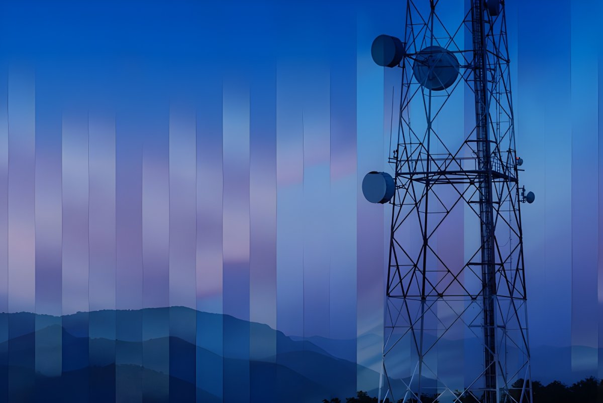 Telecommunications tower with satellite dishes against a blue dusk sky and mountain range with digital overlay effects.