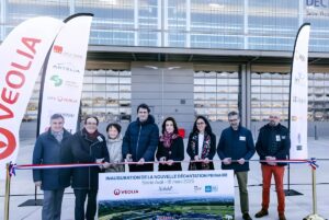 Officials cut a ribbon at a Veolia inauguration ceremony for a new primary decantation unit at a wastewater plant.