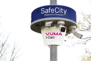 Vumacam SafeCity surveillance pole with multiple AI security cameras mounted under a branded blue and white housing.