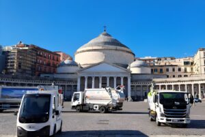 ASIA Napoli S.p.A. waste collection trucks parked in Piazza del Plebiscito in front of the San Francesco di Paola basilica.