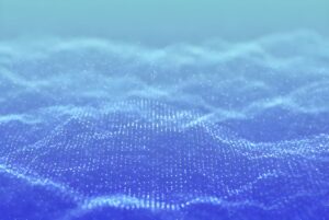 Abstract blue digital wave composed of glowing light particles and a grid pattern representing data.