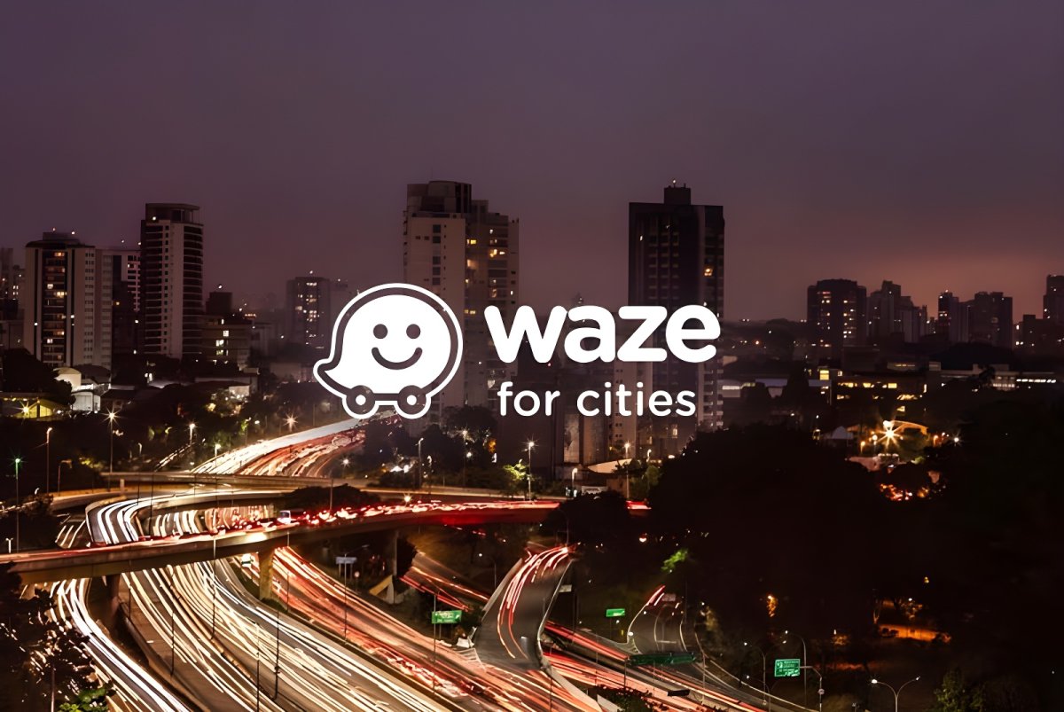 The Waze for Cities logo overlaid on a long-exposure night photograph of highway traffic light trails and city buildings.