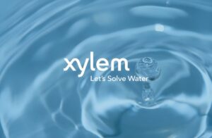 Xylem logo and "Let's Solve Water" slogan overlaid on a blue water surface with ripples and a splashing droplet.