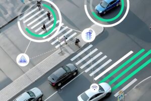 Aerial view of a city intersection with digital overlays tracking pedestrians on a crosswalk and vehicles on the road.