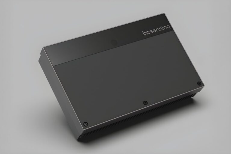 A rectangular black Bitsensing traffic sensor device angled on a gray surface.