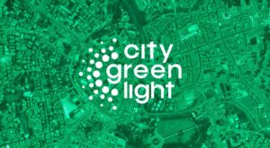 City Green Light logo centered over a green-tinted aerial satellite view of a dense urban city grid.