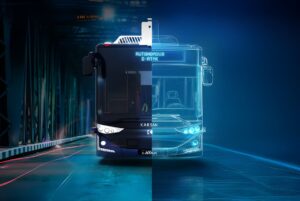 Front view of a Karsan Autonomous e-ATAK bus on a road with a digital blue wireframe overlay.