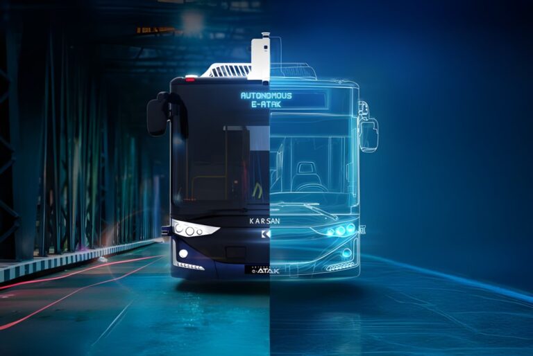 Front view of a Karsan Autonomous e-ATAK bus on a road with a digital blue wireframe overlay.