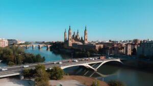 Aerial view of the Basilica of Our Lady of the Pillar and the Puente de Santiago spanning the Ebro River in Zaragoza, Spain.