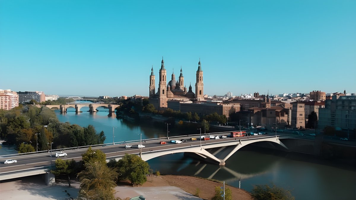 Aerial view of the Basilica of Our Lady of the Pillar and the Puente de Santiago spanning the Ebro River in Zaragoza, Spain.